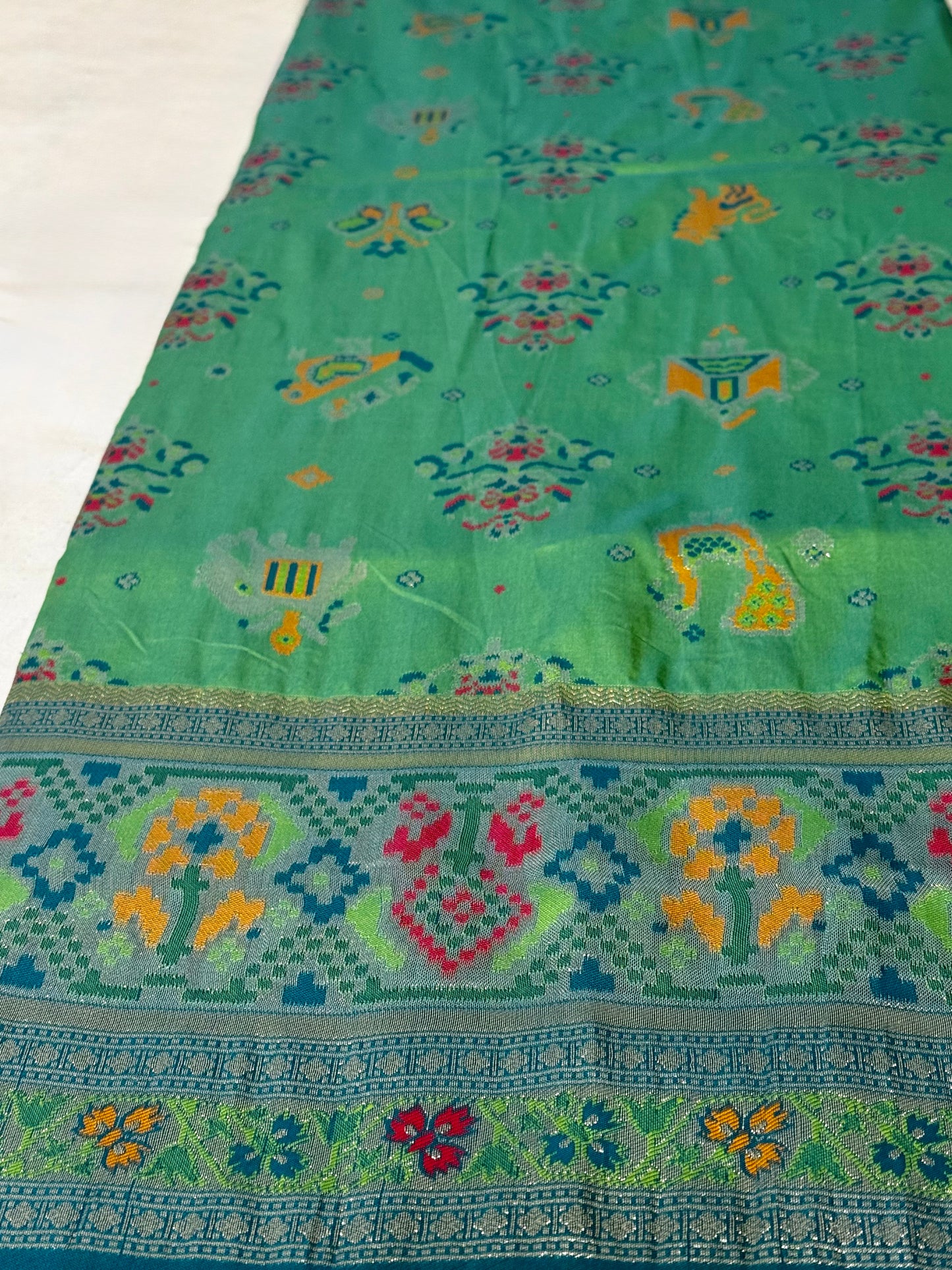 Morni – A Handwoven Green Patola Saree with Peacock and Elephant Motifs, Accented by a Teal-Silver Zari Border