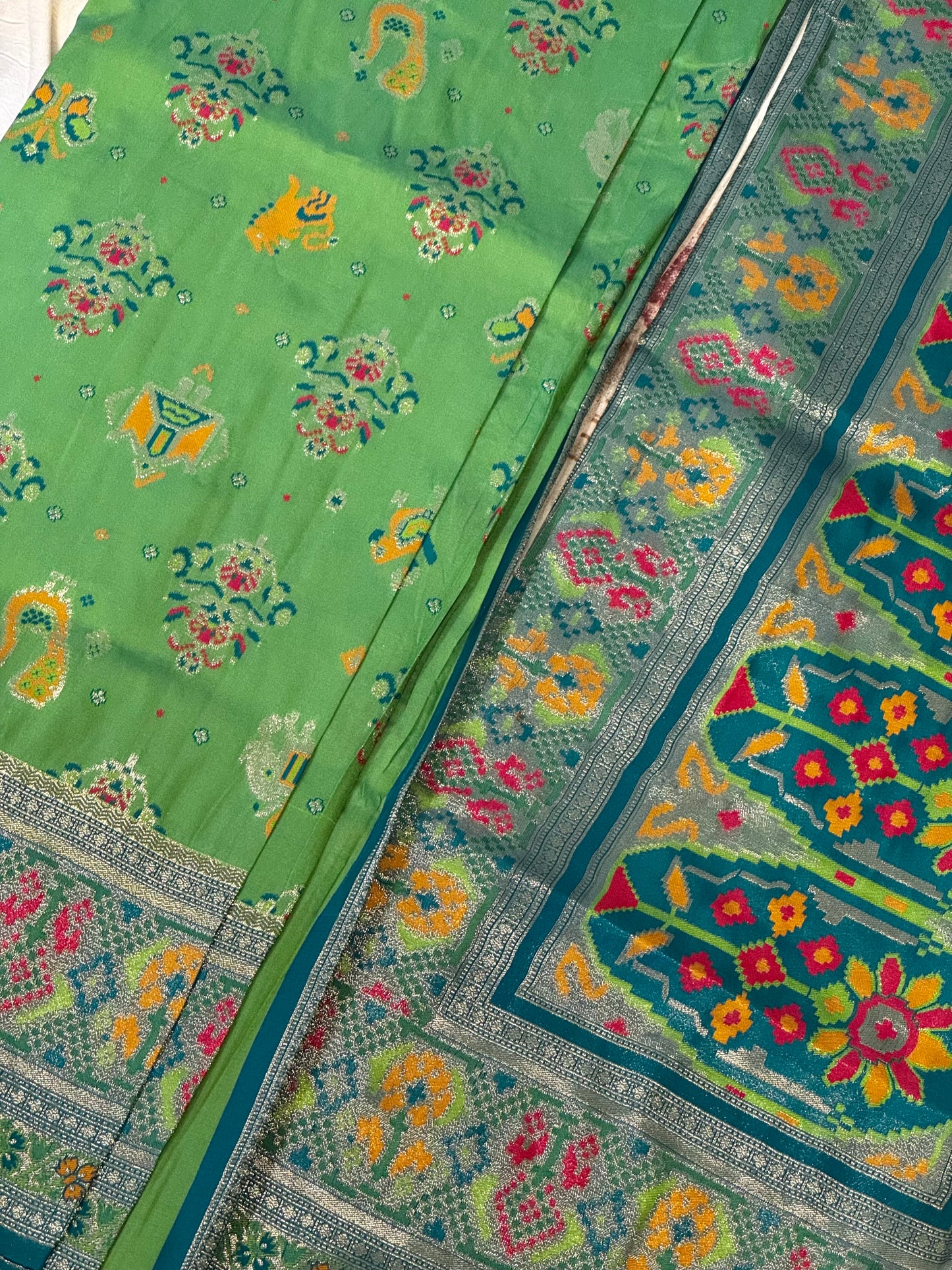 Morni – A Handwoven Green Patola Saree with Peacock and Elephant Motifs, Accented by a Teal-Silver Zari Border