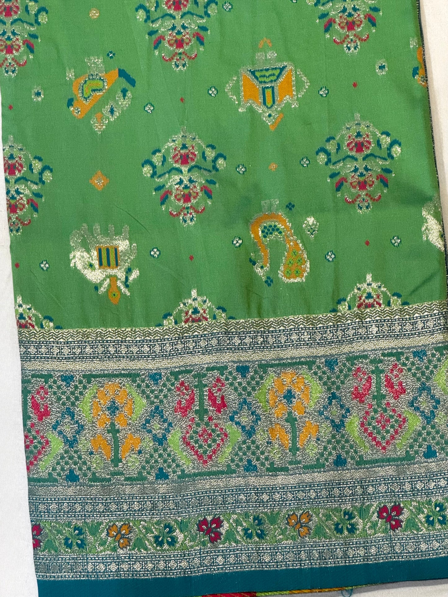 Morni – A Handwoven Green Patola Saree with Peacock and Elephant Motifs, Accented by a Teal-Silver Zari Border