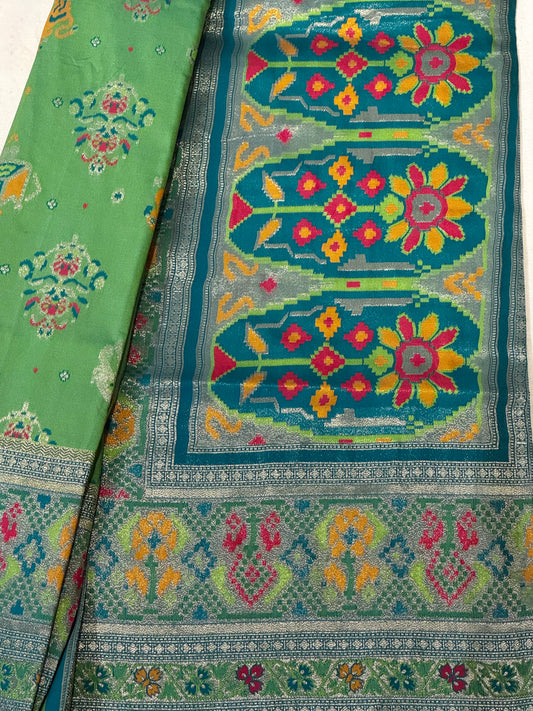 Morni – A Handwoven Green Patola Saree with Peacock and Elephant Motifs, Accented by a Teal-Silver Zari Border