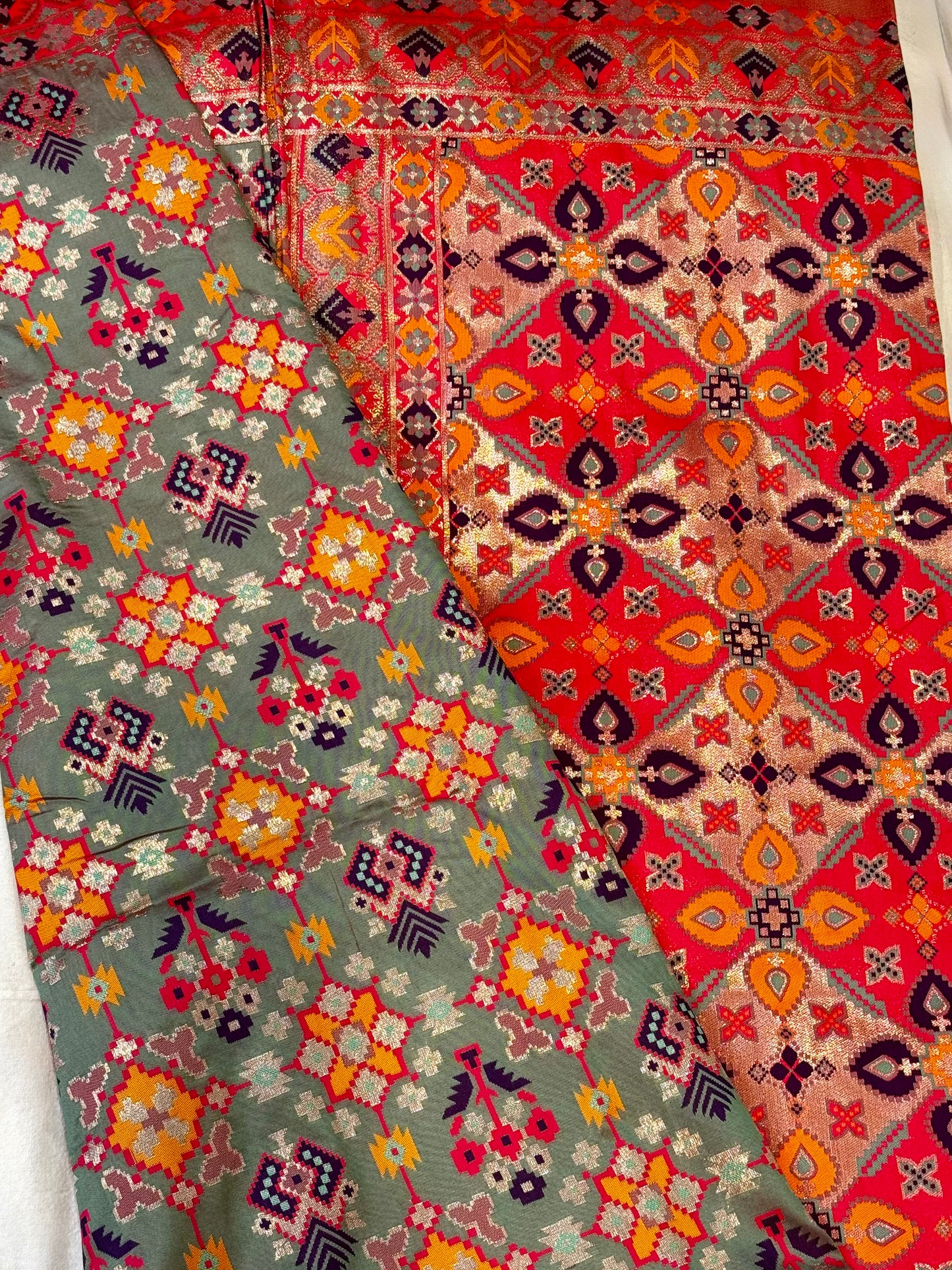 Tara – A Handwoven Green Patola Saree with Copper-Pink Border and Vibrant Ikat Motifs