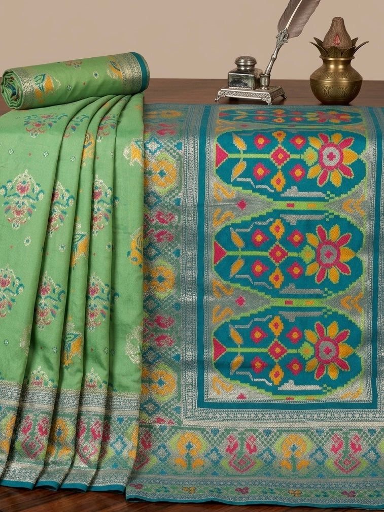 Morni – A Handwoven Green Patola Saree with Peacock and Elephant Motifs, Accented by a Teal-Silver Zari Border
