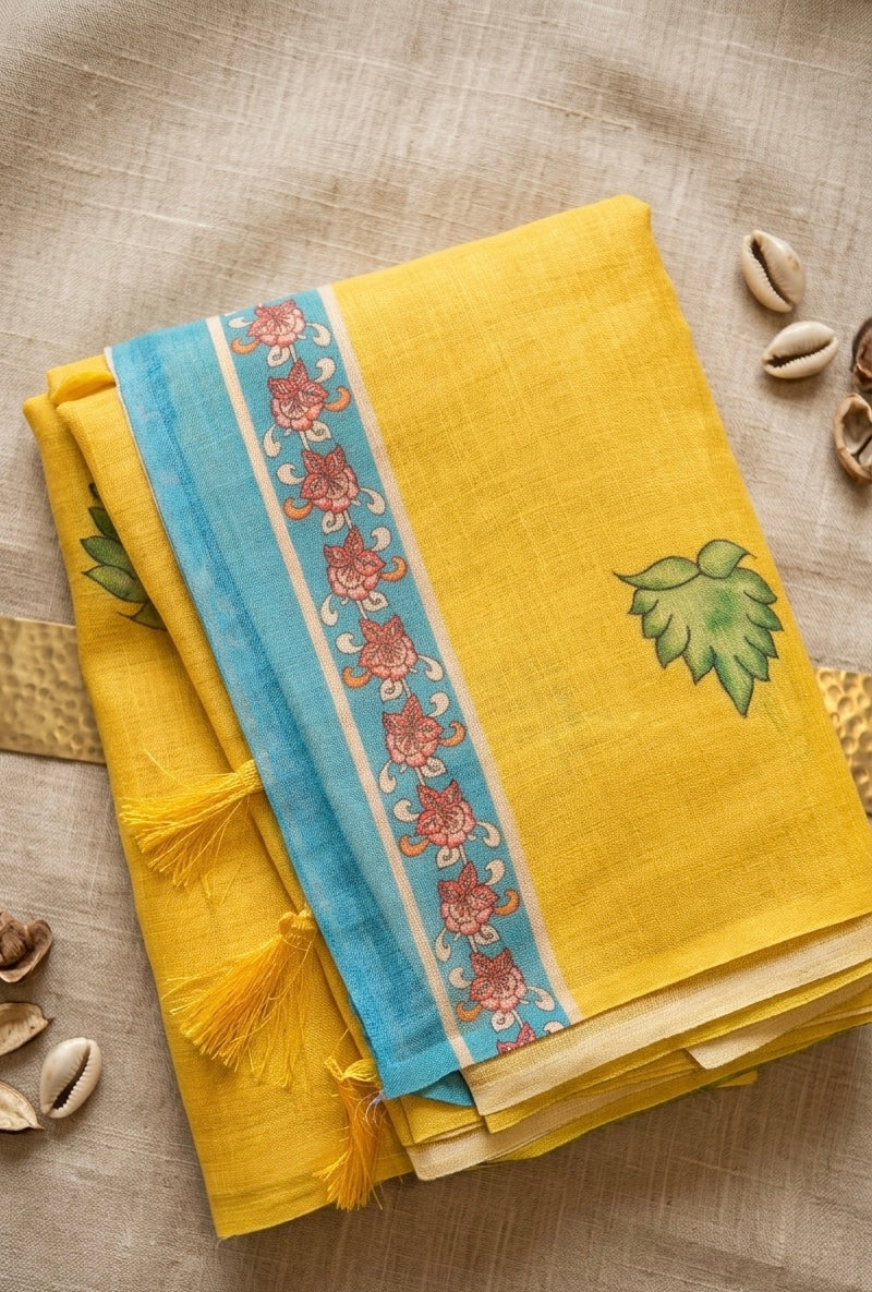 Sunayana – A Vibrant Yellow Saree with Blue Floral Border and Tassels