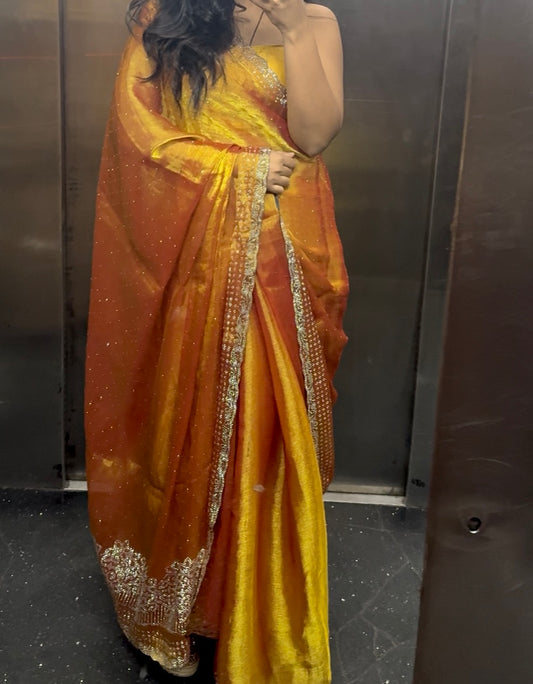 Aarika – A Sunset Gold Tissue Silk Saree with Embellished Border
