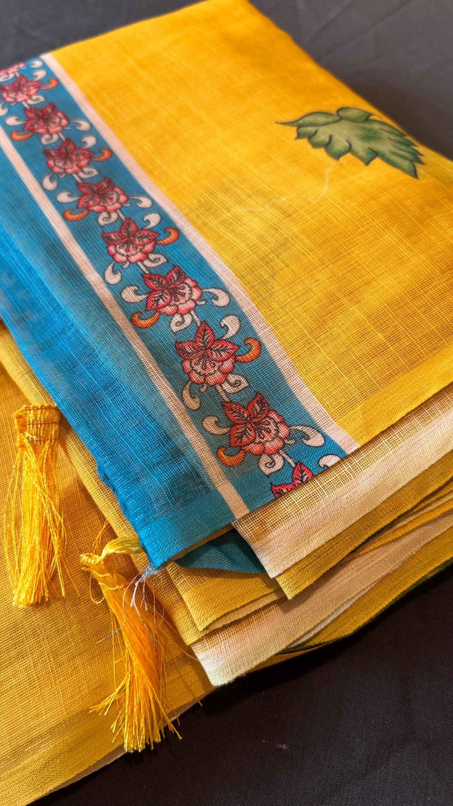 Sunayana – A Vibrant Yellow Saree with Blue Floral Border and Tassels