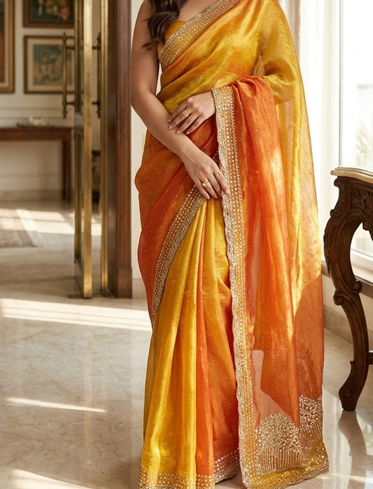 Aarika – A Sunset Gold Tissue Silk Saree with Embellished Border